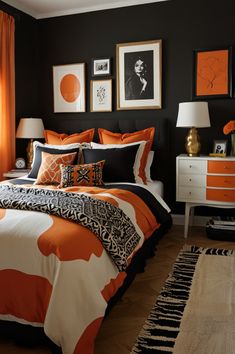 an orange and black bedroom with pictures on the wall, bed linens, lamps, and rugs