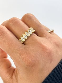 a woman's hand with a diamond ring on it