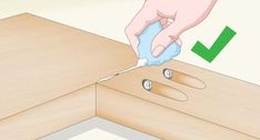 a person using a screwdriver to fix a drawer