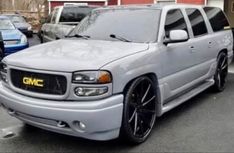 a silver truck parked in front of a building