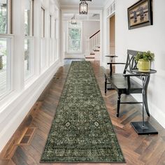 the hallway is clean and ready for guests to use it as an entrance way in this home