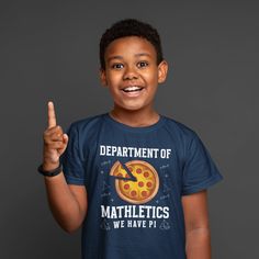 Kids Geeky Math Shirt Seed Department Of T Shirt Mathletics TShirts Teacher Geek Mathematics Scientist Gift Idea Unisex Youth Boys Girls Tee This geeky math shirt is perfect for the mathlete in your life. It reads 'Department Of Mathletics, We Have Pi', and features a large pizza with a slice cut out. It also features mathematical formulas. Makes a great gift for so many including teachers, math professors, mathematicians and just geeks like me.  Made of soft ring spun cotton. Includes our signa School Crew Neck T-shirt With Funny Text, School Fan Apparel Crew Neck Top, School Fan Apparel Tops With Crew Neck, Fun Pre-shrunk Sports T-shirt, School Shirt With Funny Text And Crew Neck, Funny Pre-shrunk Tops For School, Fun Sports Crew Neck Tops, Funny Crew Neck Sports T-shirt, Mathematical Formulas