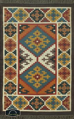 an old rug with many different colors and patterns on it, including brown, blue, orange