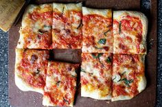 square slices of pizza sitting on top of a pan