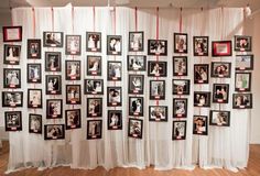 a group of pictures hanging on the wall next to each other in front of a white curtain