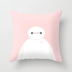 a pink pillow with a white face and black eyes