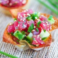 small appetizers with cucumber, radishes and sesame seeds on them