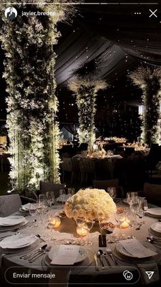 an image of a table setting with flowers and candles on the tables for a wedding reception