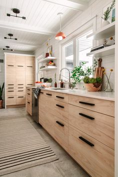 the kitchen is clean and ready for us to use it's natural wood cabinetry