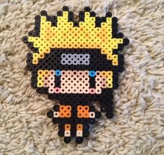 a piece of art made out of perler beads on carpeted area with rug