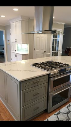 a kitchen with an oven, stove and counter tops in the middle of the room