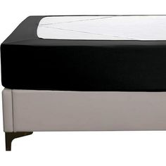 a black and white bed with no sheets on it