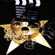 a movie clapper and some jewelry on a star