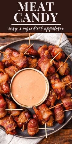 bacon skewered appetizers on a plate with dipping sauce in the middle