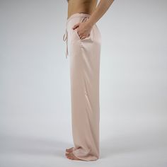 The Silk Dreamscape pants are designed from washable, 100% Mulberry Silk. It is made by specialized farms where silkworms are fed organic mulberry leaves. The pants feature a simple straight cut and have a drawstring waist that's easy to adjust for night-long comfort and pockets.  A contrasting Transcendent Pink colour offers stability and a comforting cocooning quality. Wear it alongside a shirt for a trendy look, or layer it with a camisole or kimono for added flair. Easy to match and wear!The Silk Trousers For Loungewear, Silk Bottoms With Elastic Waistband And Straight Leg, Silk Long Pants For Loungewear, Silk Wide Leg Bottoms With Relaxed Fit, Silk Wide-leg Pants With Relaxed Fit, Relaxed Fit Silk Trousers, Silk Straight Pants For Loungewear, Silk Loungewear Pants, Pink Silk Pants