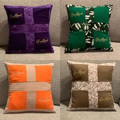 four different colored pillows sitting on top of a couch next to each other in front of a wall