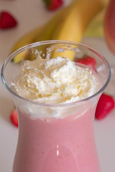 a pink smoothie with whipped cream on top