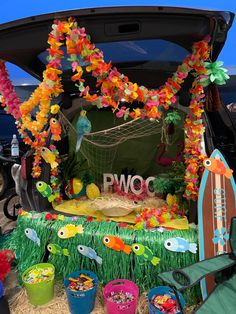 the trunk of a car decorated with tropical decorations