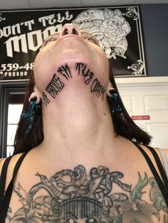 a woman with tattoos on her neck and chest