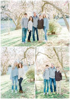 a family posing for pictures in front of some trees with blossoms on it and one man holding