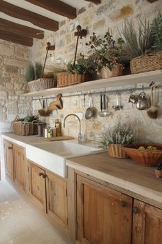 a kitchen filled with lots of wooden cabinets and counter top covered in pots and pans