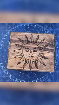 a wooden plaque with the sun on it