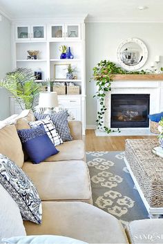 a living room filled with furniture and a fire place in the middle of a room