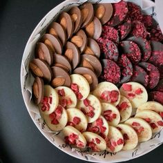 a bowl filled with lots of different types of desserts on top of a table