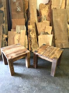 two wooden tables sitting next to each other in front of stacks of cut wood logs