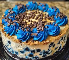 a blue and white cake with chocolate chips on top