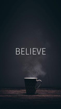 a coffee cup with steam rising out of it and the words believe written in white