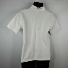 "Vintage 90s United States Liason Office Abu Dhabu UAE White Polo Shirt Size: M No Defects. Many other shirts such as this from the estate of a retired military specialist. Measurements, laying flat: Chest: 20\" Collar to hem: 28\" SIZE: M CONDITION: Pre-Owned Pre-owned" Retro White Polo Collar Shirt, Vintage White Cotton Polo Shirt, Collegiate White Moisture-wicking T-shirt, Heart Blouse, Retired Military, White Polo Shirt, White Polo, Silk Jacket, Polka Dot Blouse