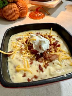 a pan filled with cheese and bacon on top of a table