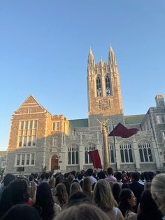 a large group of people standing in front of a building