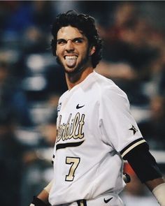 a baseball player is smiling and holding his glove