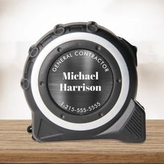 a black and white alarm clock with the name michael harrison on it's face