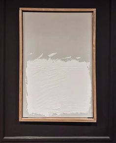 a black door with some white paint on the side and a brown frame around it