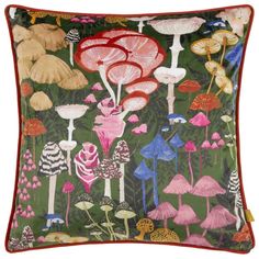 a green pillow with pink and red flowers on it