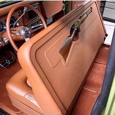 the interior of an old car with leather seats and steering wheel, including a seat cover