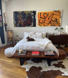 a dog laying on top of a bed in a bedroom