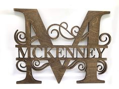 a wooden sign that says mckenney and w is in the shape of an m