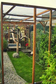 an outdoor area with green grass, rocks and wooden structures in the middle of it