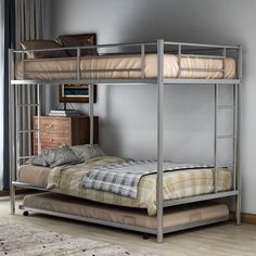 a metal bunk bed sitting next to a window