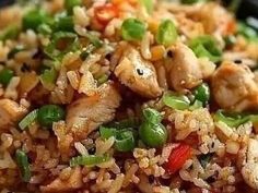 rice with meat and vegetables in a black bowl