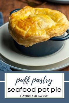 a puff pastry sitting on top of a blue dish with the words puff pastry seafood pot pie