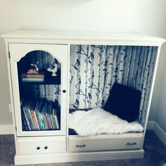 a white bookcase with books in it