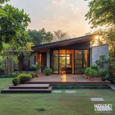 a small house with steps leading up to the front door and covered patio area, surrounded by lush greenery