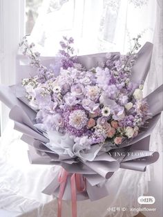 a bouquet of flowers sitting on top of a window sill