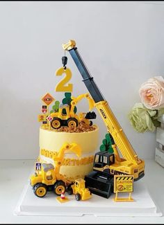 there is a cake with construction vehicles on it