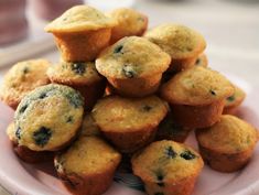 blueberry muffins stacked on top of each other on a pink and white plate